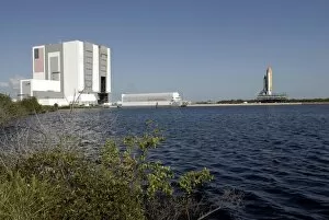 Viewed across the basin, Space Shuttle Atlantis crawls toward the launch pad