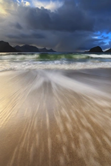 Waves washing back to sea on Haukland Beach, Lofoten, Norway Waves washing back to sea on Haukland Beach, Lofoten, Norway