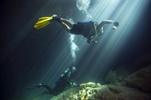 A young married couple scuba diving in Devils Den Springs Florida A young married couple scuba diving in Devils Den Springs Florida