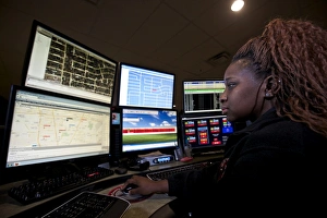 Young woman working in the emergency service dispatch control room Young woman working in the emergency service dispatch control room