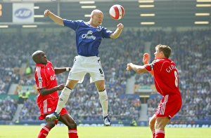 <b class=qtipBold><figcaption>Andy Johnson</figcaption></b><br>Andy Johnson soares above two Liverpool players.<br><em>© Everton</em> Andy Johnson