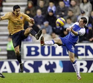 Images Dated 21st January 2007: Wigan Athletics Baines challenges Evertons Cahill for the ball during their English Premier League