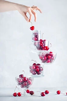 Tasty Gallery: Cherry on top of a balancing stack of bowls and cups filled with berries