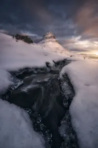 Riverbed Gallery: Rushing Water under the Mountain Peak