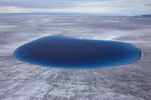 Aerial view of meltwater lake on the ice cap north-east of Sermeq Kujalleq Glacier Aerial view of meltwater lake on the ice cap north-east of Sermeq Kujalleq Glacier