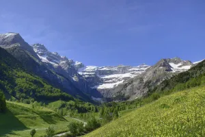 Alpine meadows and mountains above Gavarnie village with the Cirque de Gavarnie in the distance Alpine meadows and mountains above Gavarnie village with the Cirque de Gavarnie in the distance