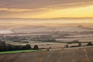 Dawn mist and rolling chalk downland viewed from Wilmington Hill, Wilmington, South Dawn mist and rolling chalk downland viewed from Wilmington Hill, Wilmington, South