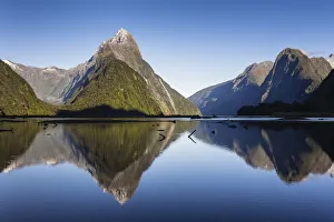 Early morning light on Mitre Peak (1683m) reflected in the calm waters of Milford Early morning light on Mitre Peak (1683m) reflected in the calm waters of Milford