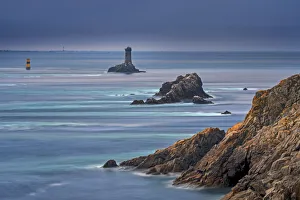 The lighthouse La Vieille in the strait Raz de Sein at dusk at the Pointe du Raz, Plogoff The lighthouse La Vieille in the strait Raz de Sein at dusk at the Pointe du Raz, Plogoff