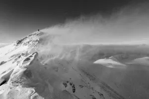 A lone hiker stands against blizzard conditions on An Teallach. Ullapool, Highlands of Scotland A lone hiker stands against blizzard conditions on An Teallach. Ullapool, Highlands of Scotland