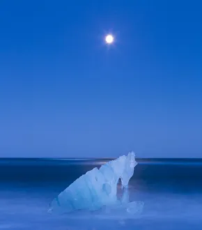 Melting ice on Jokulsarlon beach with moon. Southern Iceland, Europe, November 2012 Melting ice on Jokulsarlon beach with moon. Southern Iceland, Europe, November 2012