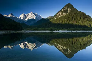 Mount Prisojnik (2, 547m) and Mount Razor (2, 601m) with reflection in a lake beside Mount Prisojnik (2, 547m) and Mount Razor (2, 601m) with reflection in a lake beside