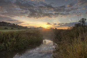 River Brue, at dawn with Glastonbury Tor in background, Somerset, UK, August River Brue, at dawn with Glastonbury Tor in background, Somerset, UK, August
