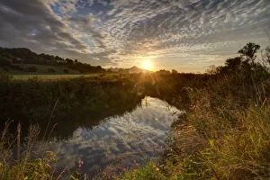 River Brue, at sunrise with Glastonbury Tor in background, Somerset, UK, August River Brue, at sunrise with Glastonbury Tor in background, Somerset, UK, August