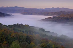 Rural landscape at dawn with low lying mist in valley, near Zarnesti, Transylvania Rural landscape at dawn with low lying mist in valley, near Zarnesti, Transylvania