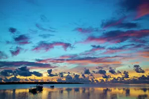 Micronesia Gallery: The sky lights up at dawn with boats floating on still waters off the island of Yap, Micronesia