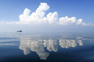 Images Dated 9th March 2017: Small boat on calm waters with reflections of cloud formations, Gulf of Thailand, Pacific