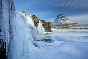Snow covered Kirkjufell Mountain and frozen waterfalls,, Snaefellsness Peninsula Snow covered Kirkjufell Mountain and frozen waterfalls,, Snaefellsness Peninsula