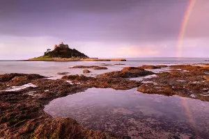 St Michael's Mount at sunrise with a rainbow over Penzance, viewed from Marazion St Michael's Mount at sunrise with a rainbow over Penzance, viewed from Marazion