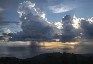 Sunset with dramatic rain clouds during hurricane season. Dominica, West Indies Sunset with dramatic rain clouds during hurricane season. Dominica, West Indies