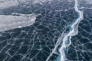 Cracked Gallery: Transparent black ice with cracks on Lake Baikal, aerial shot