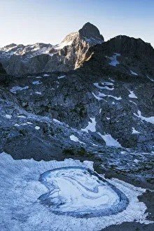 Upper Kriz Lake with ice melting, Mount Triglav (2, 864m) in the distance, Triglav National Park Upper Kriz Lake with ice melting, Mount Triglav (2, 864m) in the distance, Triglav National Park