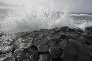 Wave crashing onto basalt rocks, Giant's Causeway, Unesco Heritage Site, Northern Ireland Wave crashing onto basalt rocks, Giant's Causeway, Unesco Heritage Site, Northern Ireland