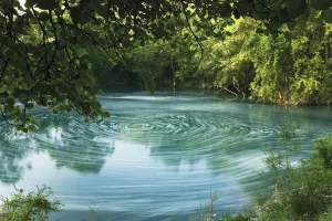 Whirl pool with foam (from waterfall) or pollution floating on surface, Trebizat River Whirl pool with foam (from waterfall) or pollution floating on surface, Trebizat River