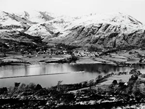 Prints of Bluebird K7 on Coniston Water, Cumbria, possibly Christmas Day, 1966. A view looking down on the lake and the surrounding mountains. Bluebird can be seen speeding along the lake Cumbria Prints: Bluebird K7 on Coniston Water, Cumbria Print 1966
