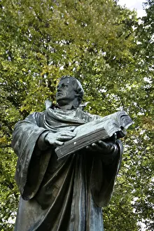 Martin Luther Prints: Print of a bronze statue depicting Martin Luther holding an open Bible