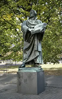 Martin Luther Prints: Print of a bronze statue depicting Martin Luther holding an open Bible