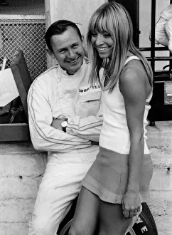 Bruce McLaren with female admirer in the pits, 1967 Italian Grand Prix. Creator: Unknown Bruce McLaren with female admirer in the pits, 1967 Italian Grand Prix. Creator: Unknown