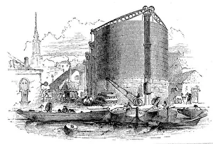 Exterior view of City of London Gasworks, showing gasometers and coal barges at the quay Exterior view of City of London Gasworks, showing gasometers and coal barges at the quay
