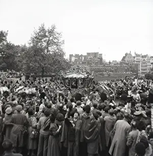 Prints of Gold State Coach, Coronation of Queen Elizabeth II, London, 2 June 1953. Crowds watching the procession pass St James's Palace on the way to Buckingham Palace Palace Prints: Print of Gold State Coach at the Coronation Procession