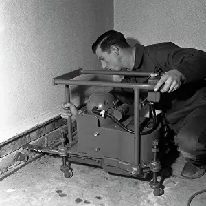 Installing a damp proof course in a house in Goldthorpe, South Yorkshire, 1957. Artist Installing a damp proof course in a house in Goldthorpe, South Yorkshire, 1957. Artist
