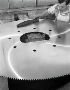 A machinist quality checking a six foot circular saw blade, Sheffield, South Yorkshire, 1963 A machinist quality checking a six foot circular saw blade, Sheffield, South Yorkshire, 1963