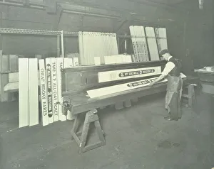 Man stencilling signs for tram cars at Charlton Central Repair Depot, London, 1932 Man stencilling signs for tram cars at Charlton Central Repair Depot, London, 1932