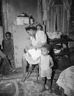 A mother getting the children ready for a neighborhood birthday party, Washington, D.C. 1942. Creator: Gordon Parks A mother getting the children ready for a neighborhood birthday party, Washington, D.C. 1942. Creator: Gordon Parks