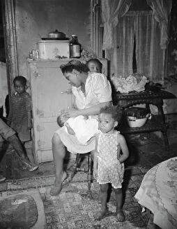 Preparations Gallery: A mother getting the children ready for a neighborhood birthday party, Washington, D.C. 1942