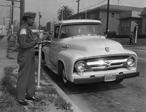 Pick Up Truck Gallery: Parking meter with Los Angeles parking control officer 1958. Creator: Unknown