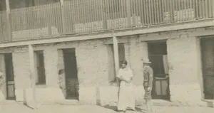 Photograph of a man and woman standing on a sidewalk, early 20th century Photograph of a man and woman standing on a sidewalk, early 20th century