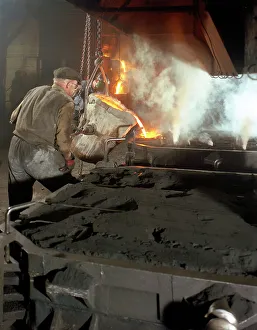 Pouring molten metal from a cupola into moulds, steel bath production, Hull, Humberside Pouring molten metal from a cupola into moulds, steel bath production, Hull, Humberside