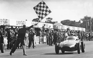 Stirling Gallery: Stirling Moss winning 1957 British Grand Prix at Aintree in the Vanwall. Creator: Unknown