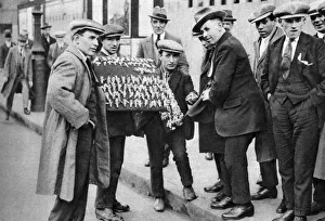 Street hawker selling football favours in Kings Cross, London, 1911 (1926-1927) Street hawker selling football favours in Kings Cross, London, 1911 (1926-1927)