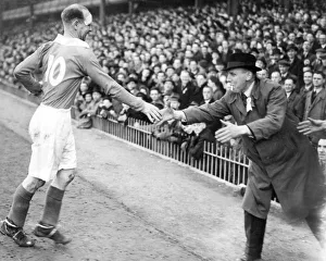 A Charlton supporter dashes out to shake hands with Don Welsh A Charlton supporter dashes out to shake hands with Don Welsh