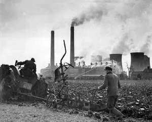 Ploughing in Warwickshire with Harris Hall electricity power station in the background Ploughing in Warwickshire with Harris Hall electricity power station in the background