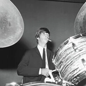 Singers Gallery: Ringo Starr smokes a cigarette at the drums as the Beatles perfo