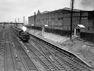 Railways Gallery: Train passing Manchester United Football Ground, 1935