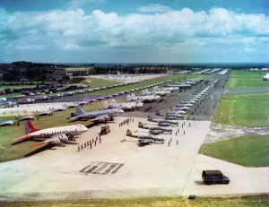 <b class=qtipBold><figcaption>100 years of the RAF</figcaption></b><br>The Coronation Review of the Royal Air Force by HM Queen Elizabeth II celebrating her coronation which had taken place at the beginning of June. The event held at RAF Odiham, 15th July 1953 was the culmination of seven month's planning can be seen in this view of the immaculately parked aircraft and their crews as they wait in the afternoon sun for Her Majesty to inspect them. This display was the largest display of military airpower that this country has ever seen (still to this day). Over 300 static aircraft and a fly past of over 600 aircraft. Aircraft included: Static Display Avro Anson (various marks) (7) Auster AOP6 (6) Bristol Freighter Mk31E (1) Canadair Sabre (12) Canadair Sabre F1(4) English Electric Canberra B2 (5) English Electric Canberra PR3 (1) DHC Chipmunk T10 (58) DH Devon C1 (2) NA Harvard T2B (12) HP Hastings Mk1 (1) HP Hastings C1 (2) HP Hastings C2 (2) HP Hastings C4 (1) Avro Lancaster GR3 (4) Avro Lincoln (8) Gloster Meteor T.7 (17) Gloster Meteor Mk3 (4) Gloster Meteor Mk7 (2) Gloster Meteor F.8 (19) Gloster Meteor FR9 (4) Gloster Meteor Mk9 (8) Gloster Meteor NF11 (20) Lockheed Neptune MR1 (4) Airspeed Oxford (9) Percival Prentice T1 (12) Percival Provost T1 (4) Avro Shackleton MR1A (3) Avro Shackleton MR2 (1) Bristol Sycamore HR12 (1) Vickers Valetta T3 (4) DH Vampire T11 (4) DH Vampire Mk3 (8) DH Vampire FB5 (17) DH Vampire FB9 (14) DH Vampire NF10 (3) Vickers Varsity T1 (5) DH Venom FB1 (4) Boeing Washington B1 (4) Tiger Moth G-AHUT Auster AOP 6 Canberra PR3 (2) Harvard 2B.6 Hastings C1 (2) Hastings C2 Meteor T7 Spitfire LF16e.1 Flypast Bristol Sycamore HC1 (1) Airspeed Oxford 1 (12) Avro Anson (21) Avro Lincoln (45) Avro Shackleton MR1A and MR2 (18) Avro Vulcan Prototype (1) Boeing Washington (12) BP Balliol T2 (12) Canadair Sabre F4 (24) Canadair Sabre (36) DHC Chipmunk T10 (32) DH Vampire T10 (12) Vampire FB5 (12) DH Vampire FB5 (12) DH Vampire T11 (1) DH Venom FB1 (24) English Electric Canberra (48) Gloster Meteor F4 (12<br><em>© Crown copyright</em> 100 years of the RAF