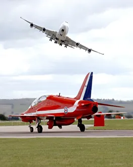 On Boeing 747 Swoops Over a Royal Air Force Red Arrow at Air Show On Boeing 747 Swoops Over a Royal Air Force Red Arrow at Air Show